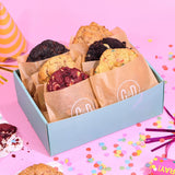 6 x New York Cookies The BIG Birthday Box with six different flavors in a Crumbs & Doilies gift box on a pink party background